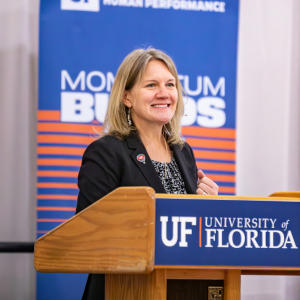 Katie Witkiewitz smiles at the podium.